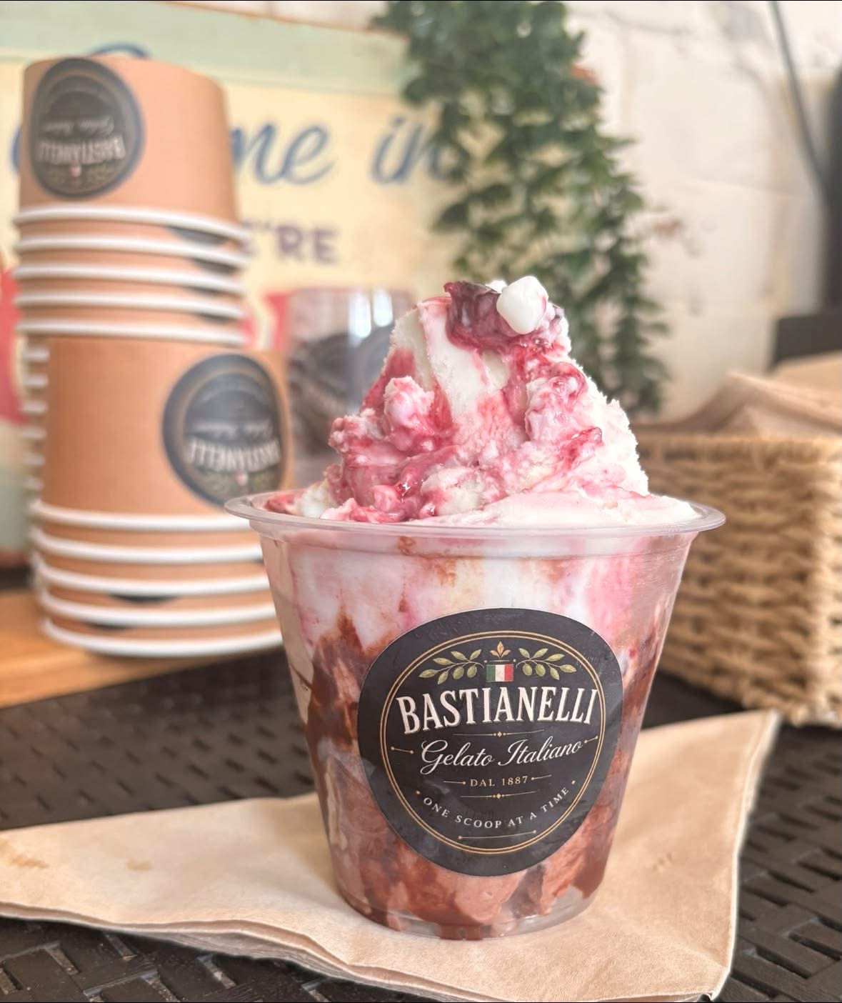 Bastianelli gelato sundae with berry sauce in a branded cup
